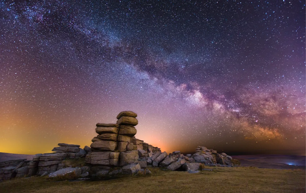 A view of the milky way from a rocky terrain.