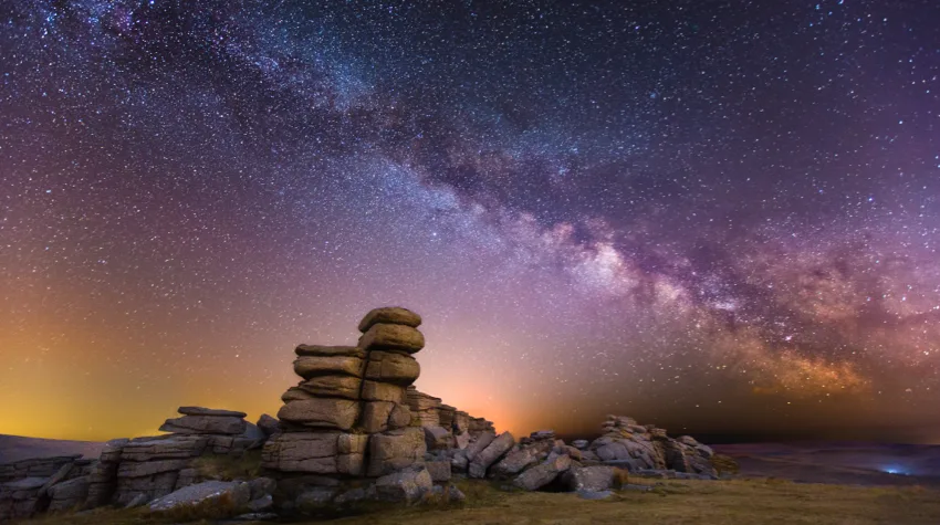 A view of the milky way from a rocky terrain.