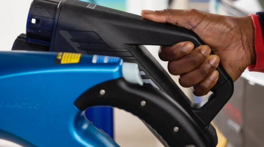 A man holding an electric charger.