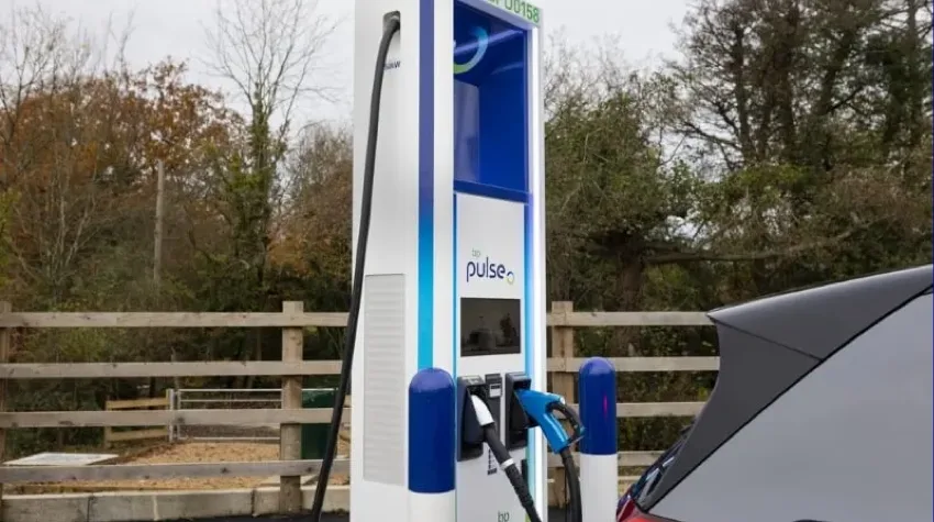 A car parked near a bp pulse charging station.