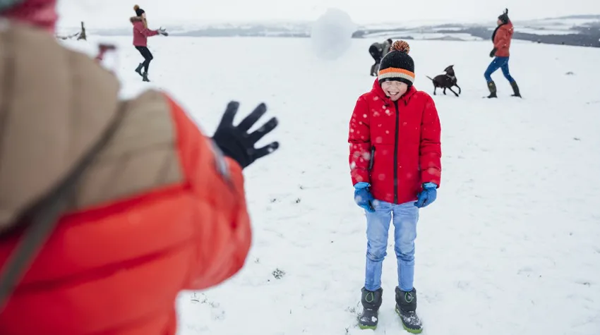 Children enjoying with snow fall