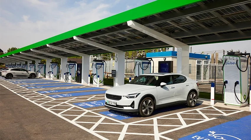 Electric vehicle charging at a bp pulse EV charging station during daytime