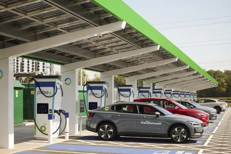 A row of cars sit charging under a canopy at a bp pulse charging hub.