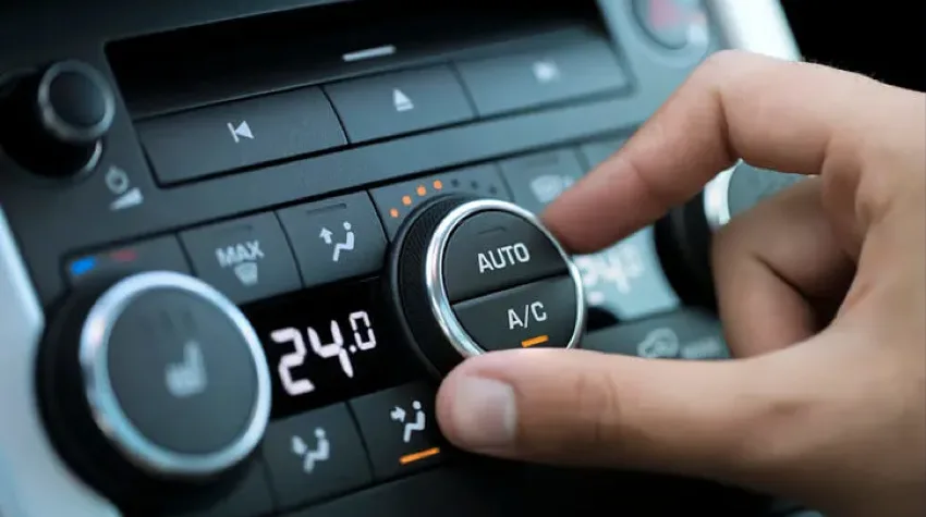 A person using their thumb and index finger to control the AC dial in an Electric Vehicle.