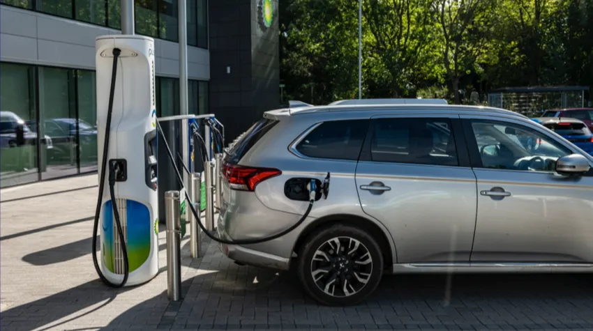 A silver EV charging at a bp pulse charger.