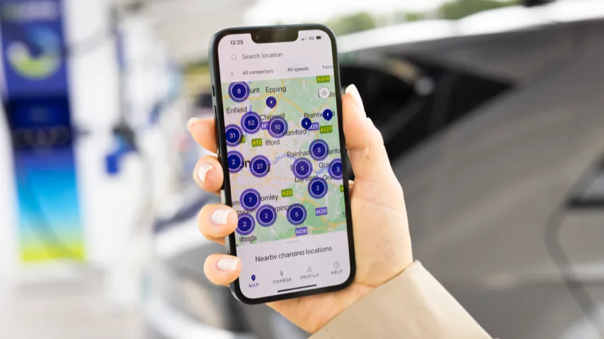 A close up of a person's hand holding a mobile phone displaying the bp pulse live map.