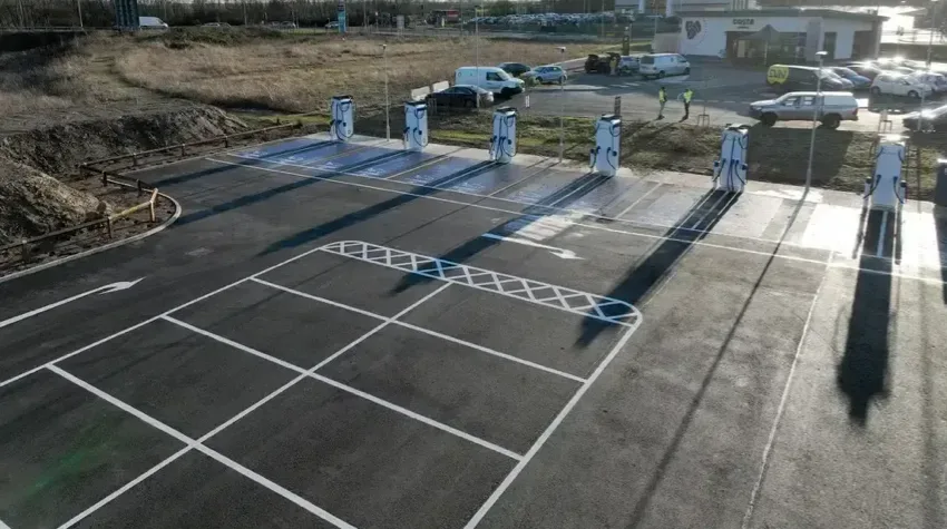 A high angle view of bp pulse chargers lined at the side of a parking lot.