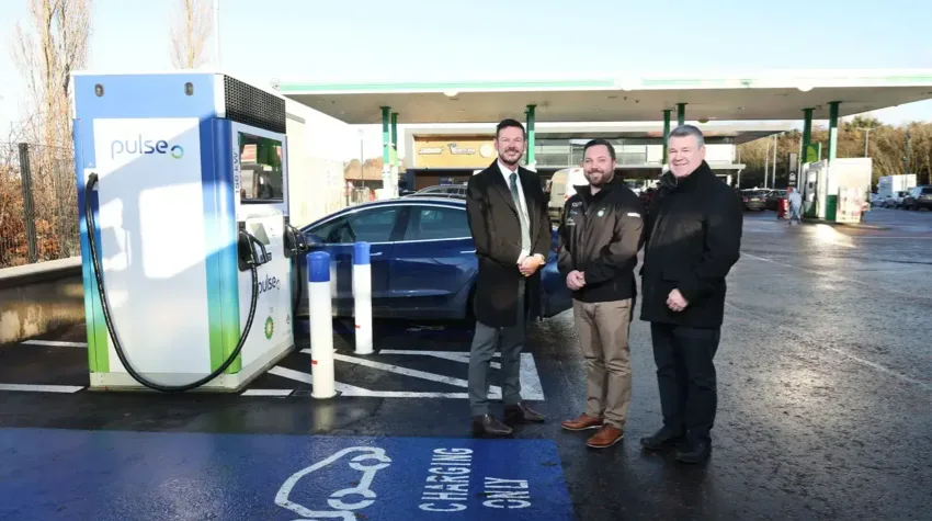 Ron Whitten from Henderson Group is pictured with Easton Boyd from bp and Brian Hughes from the Electric Vehicle Association NI at one the new bp pulse electric vehicle charging points.
