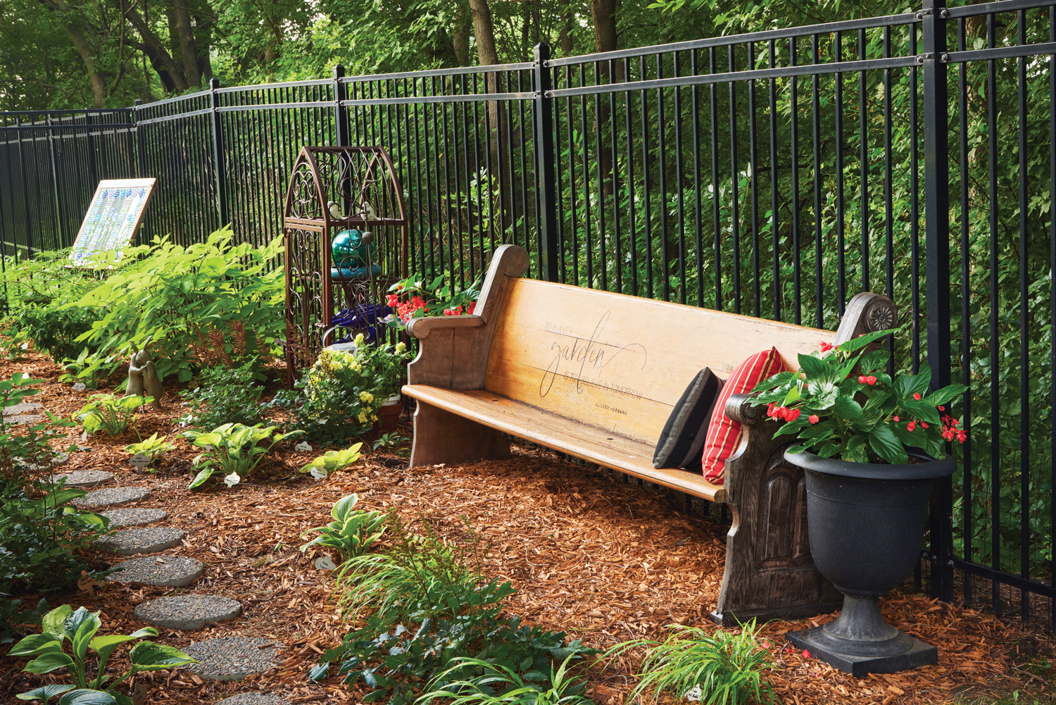 185 RGA church pew in the garden: A resting spot near the vegetable garden — because they don’t have enough indoor storage space for it, Sue bought a furniture cover for the church pew, “cinches it tight and says a prayer” over winter.