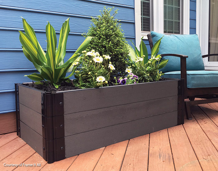 Frame-It-All raised garden bed kit on a patio courtesy of Frame-It-All: With only a hammer or rubber mallet required, Frame It All raised beds are easy to setup!