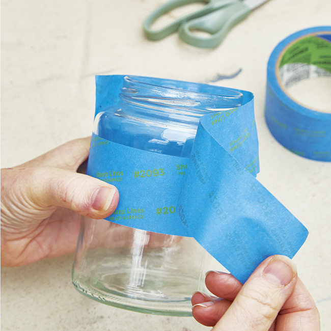 diy-jar-lantern-taping: Avoid overspray by masking off the top portion before painting the bottom section.