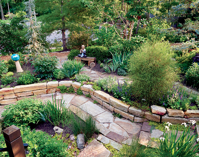 Bonnie Duma garden stone pathway: The stones that make up the retaining wall in the backyard were originally part of the barn foundation on the farm owned by Bonnie’s great grandparents. If you look closely while walking the pathway, you might spot initials carved into the stones.