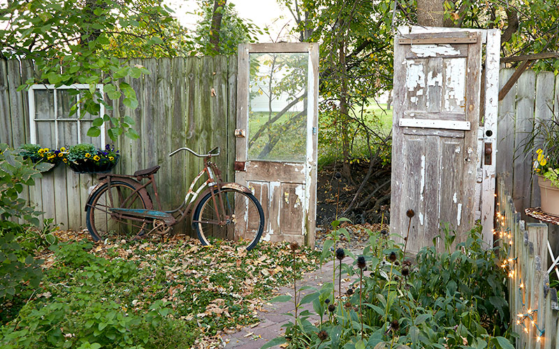 Upcycled doors and old window for planter: Upcycled materials add charm to this backyard retreat.