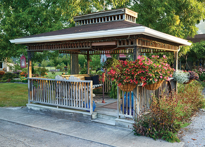 Light feature Garden gazebo: Originally the hand pump was surrounded by a brick-edged flower bed but Rachel talked Jim into building the gazebo when they lost the shade from a nearby poplar (Populus spp.) tree. 
