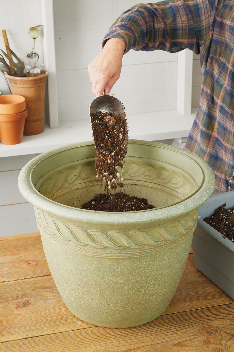 GG163 Fill containers with soil: Prefill your garden containers for a jump start on spring planting.
