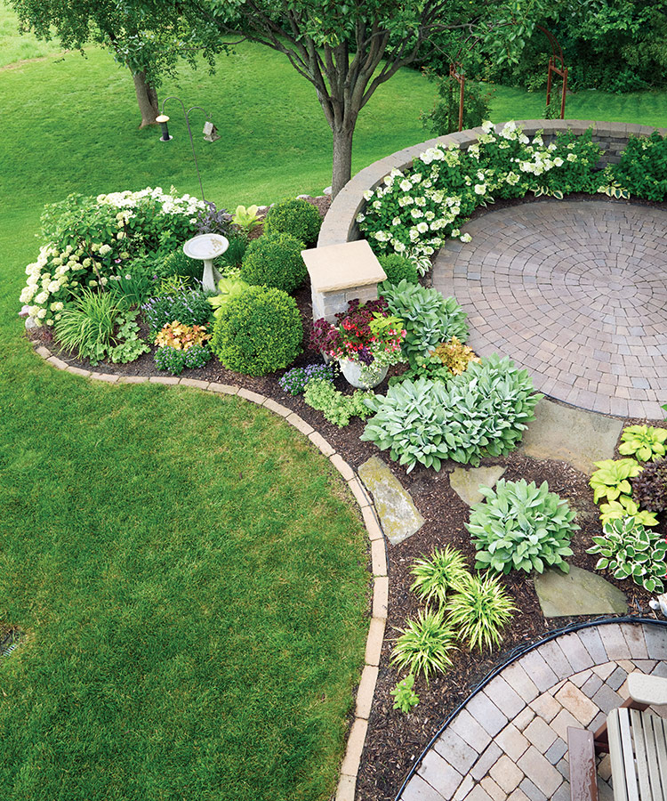 Joyce Ludlow aerial patio view: Curves add interest The perfect circle patio and the curving bed shapes around it make for a beautiful combination, especially when viewed from the second-story deck.
