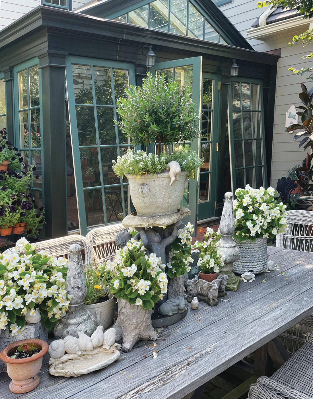 Becky Short container planting group with topiary: Use a variety of garden containers planted with the same plant to create a unique but cohesive look.