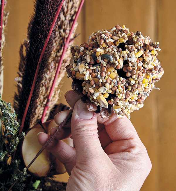 Add a pinecone peanut butter treat to the bird-feeding obelisk: Make an easy treat to tuck into your obelisk by smearing a pinecone with peanut butter and birdseed!