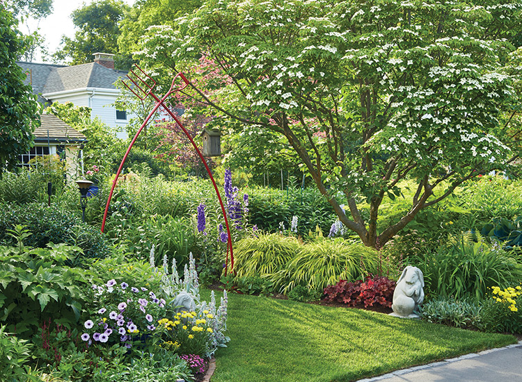 Sensory garden red arbor: This vibrant red arch instantly catches your eye, creating a striking focal point inviting you to enter the garden. 