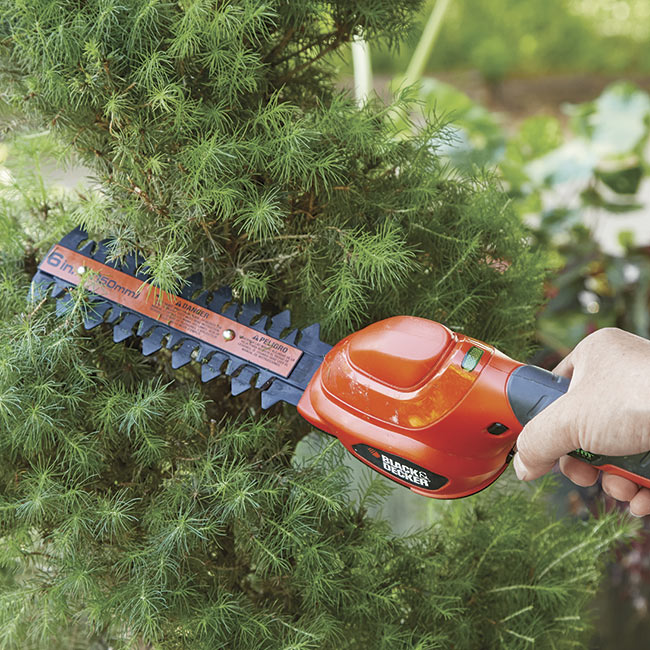 battery-powered-hand-held-shear-in-action: An integrated battery makes this hand-held shear lighter than one with a battery pack.