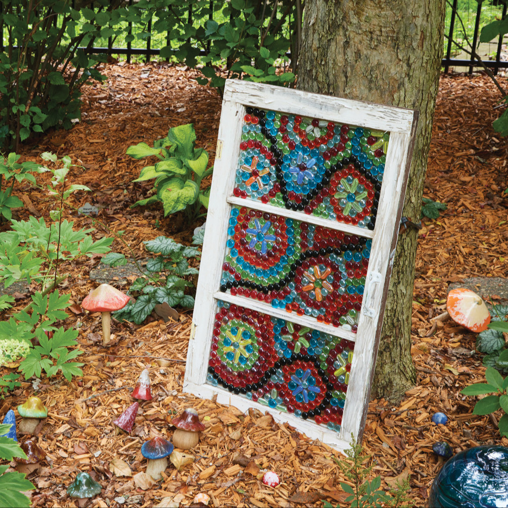DIY Mosaic art ornament in the garden: Sue arranged flat glass beads on these old windows, then secured each one with E6000® waterproof glue to create these DIY mosaics.