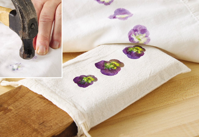 flower pounding on fabric hammering flowers: Use a hammer to softly pound flowers for the best transfer. Check progress and adjust if necessary.