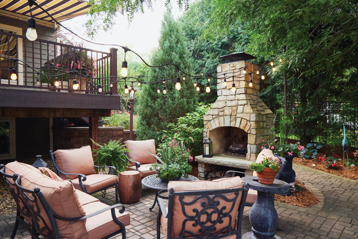 185 RGA Olson's back patio fire pit and seating area: Late-season enjoyment — The wood fireplace gets the most use in the fall as the weather cools down and the mosquitos are less active.