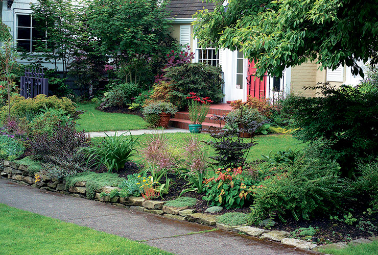 Koelink feature front walkway planting: At just 70 feet wide and 35 feet deep, this garden is packed with plants and visual interest.