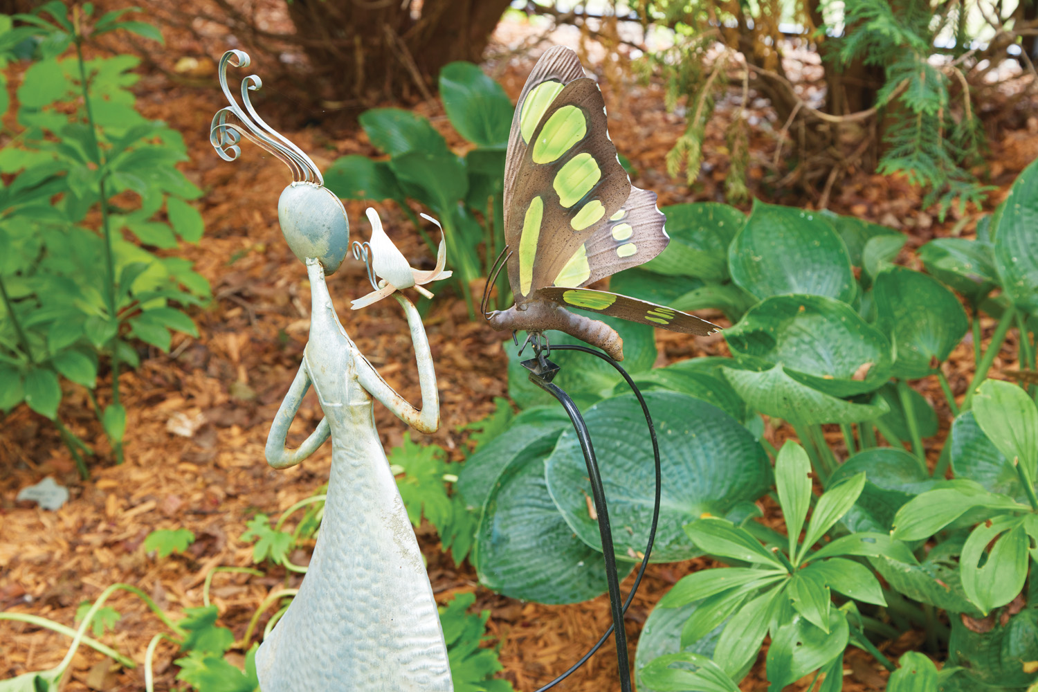 185 RGA Butterfly garden ornament: These ornaments call back a time when a butterfly’s appearance brought Sue solace. It’s one of many such themed gardens throughout the backyard.