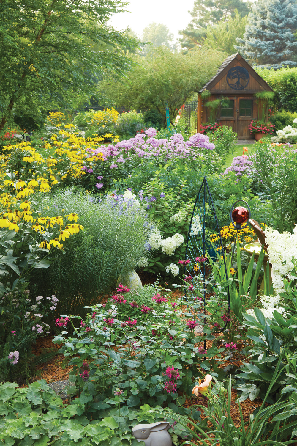 185 RGA Olson's Garden shed and perennial bed in summer: Many plants, such as garden phlox, bee balm and cutleaf coneflower, do best if they’re divided every few years.