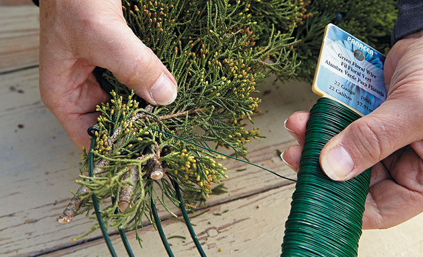 bird-feeding-wreath-construct: Wrap the paddle wire around each bundle’s stem end as tightly as you can, fastening it to the frame like you see in the photo above.