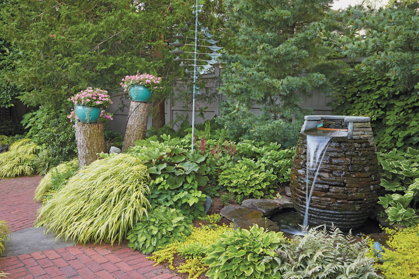 GG164 Joyce Hannaford's shade garden custom water fountain: This custom water feature adds charm and sound to the backyard and is sited in a spot where they can also hear what's happening indoors when they have the windows open.