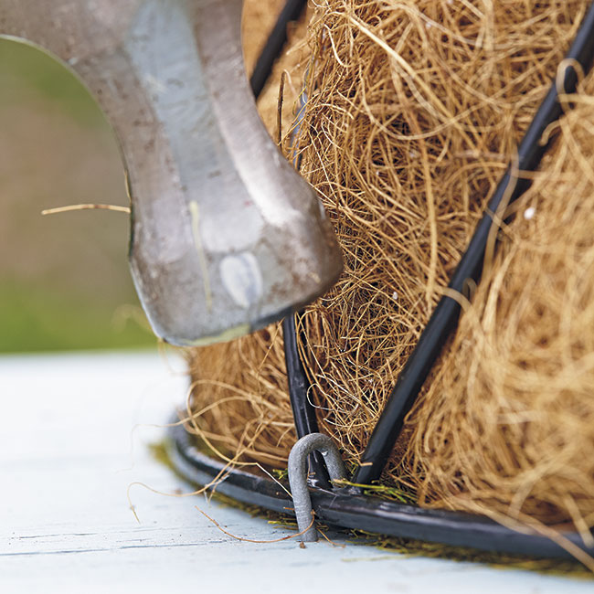 hammer-staple-through-basket: Hammer a steel staple in every 2 to 3 in. to keep the basket secure.