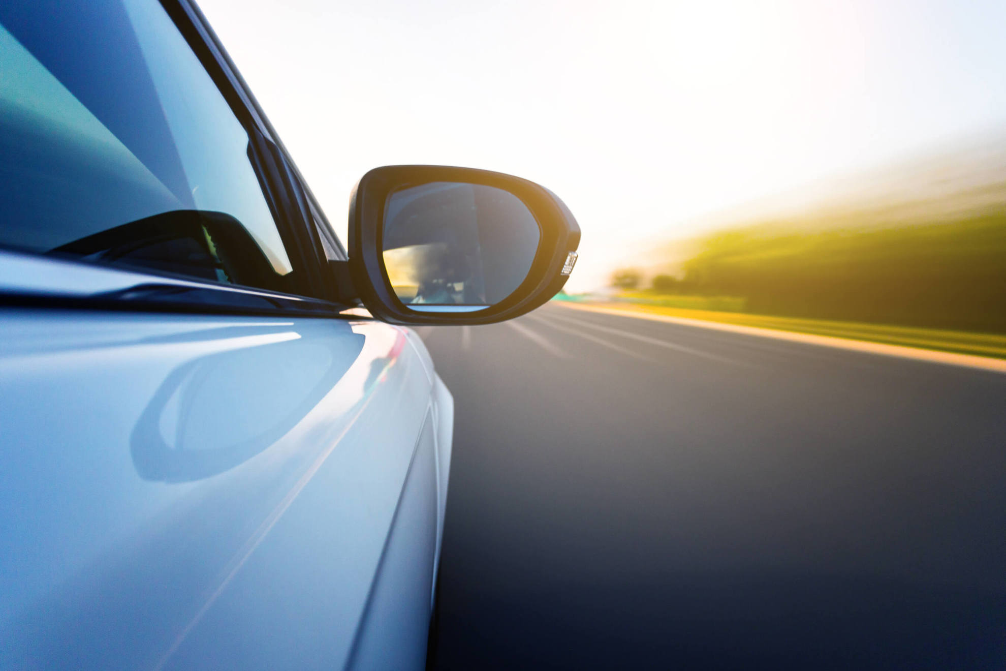 Car wing mirror and open road