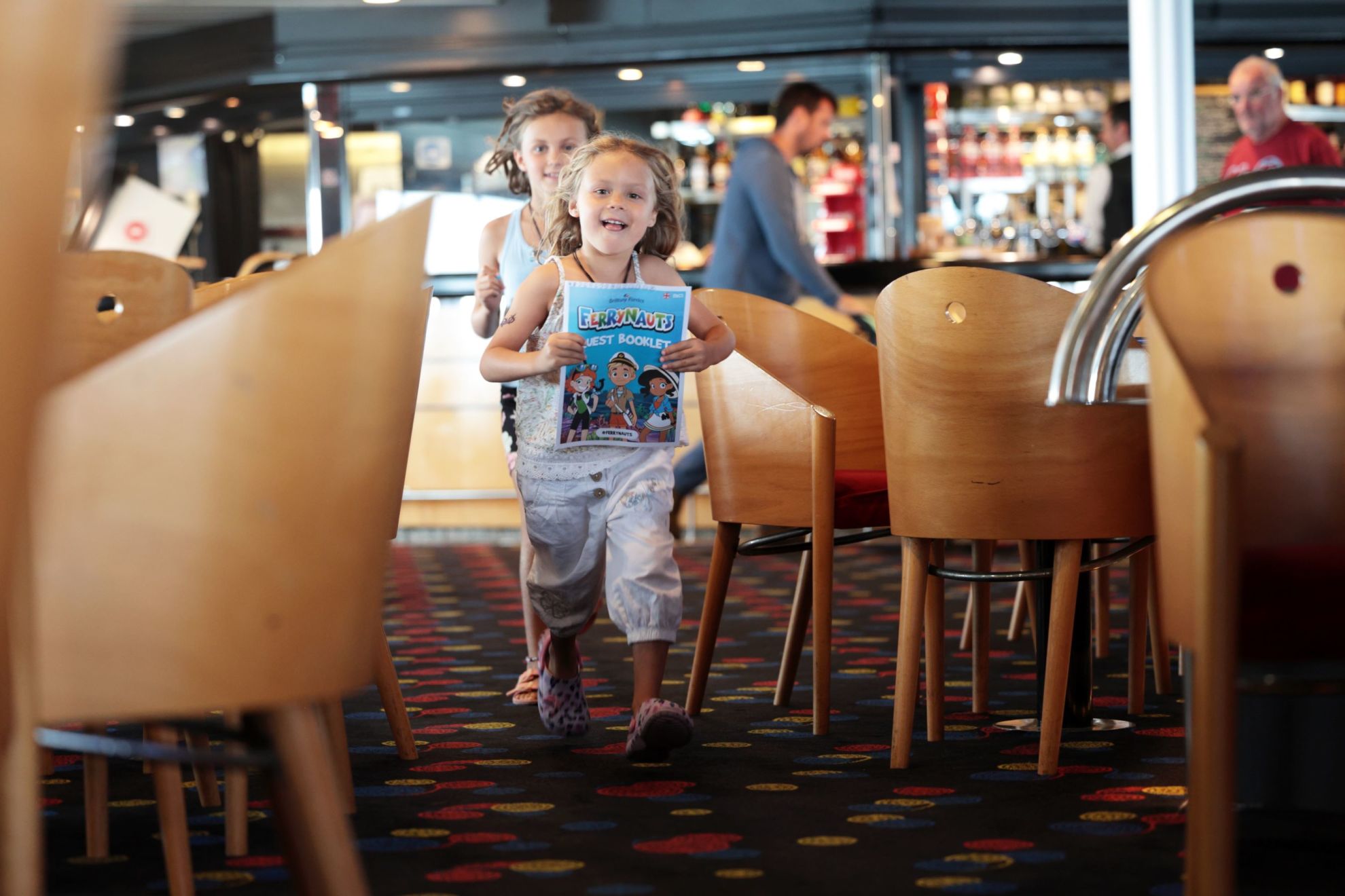 Children in the bar with Ferrynauts booklet