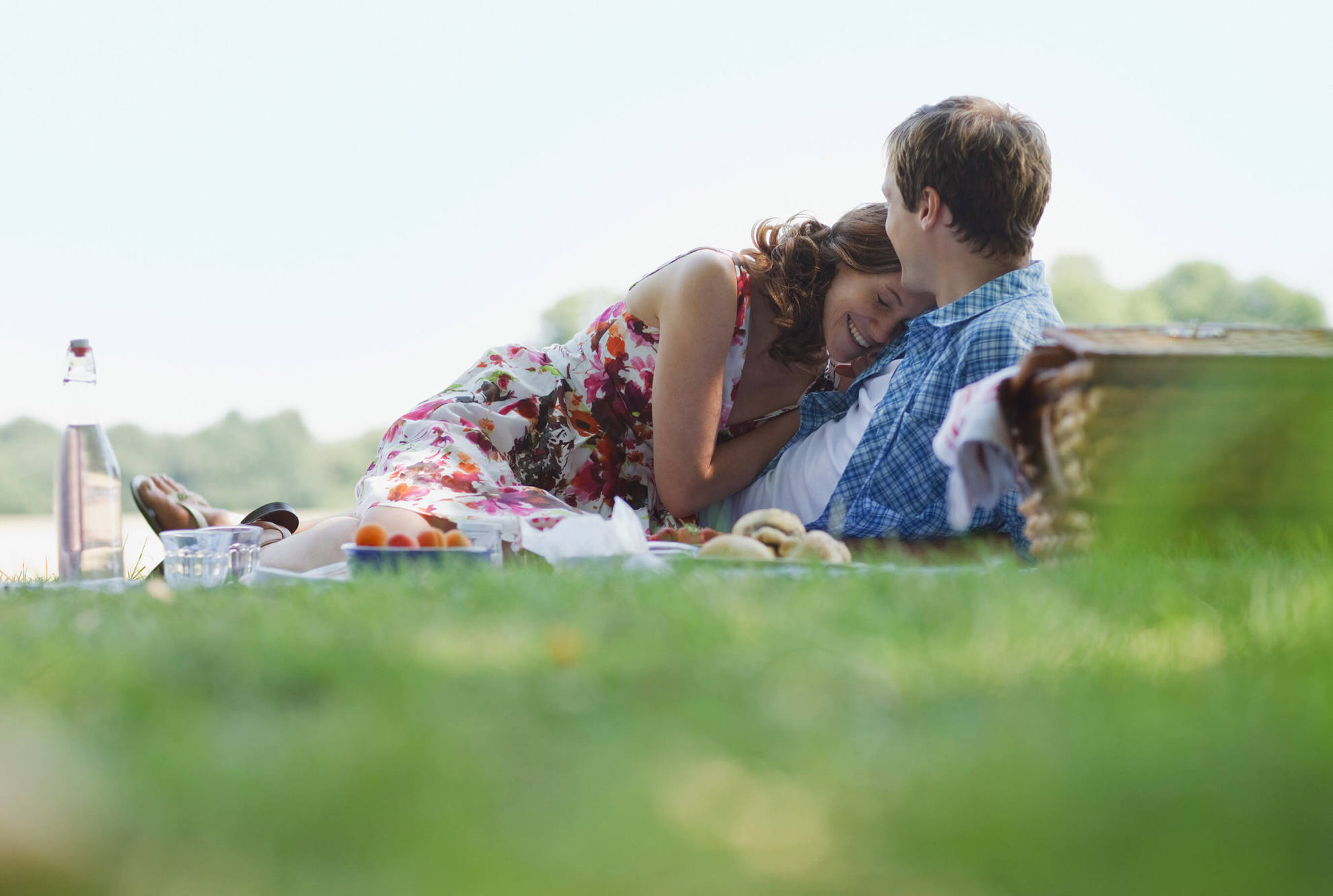 Couple having picnic and cuddling
