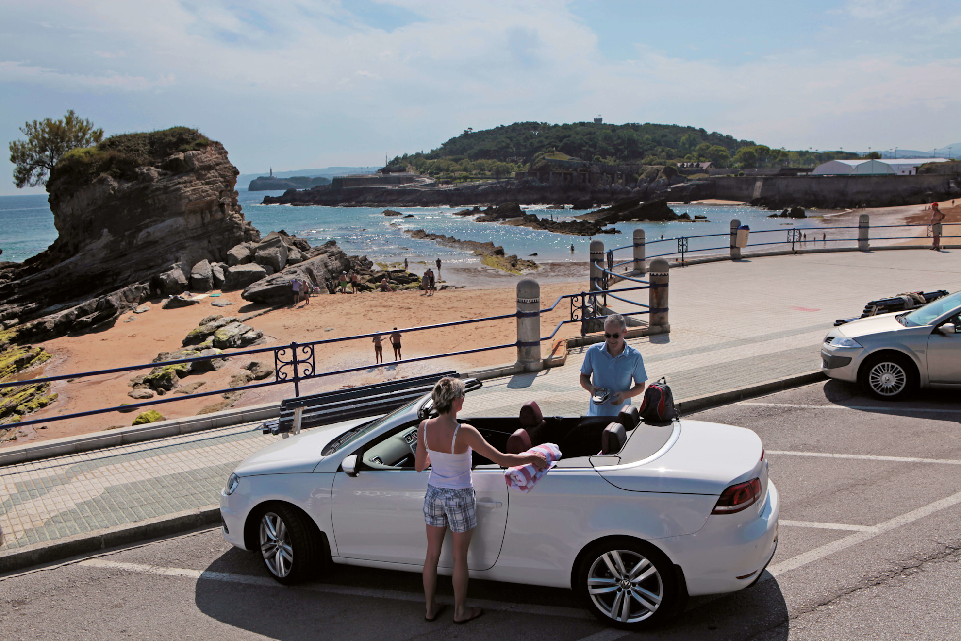 Couple with a car on the promenade in Santander, Cantabria