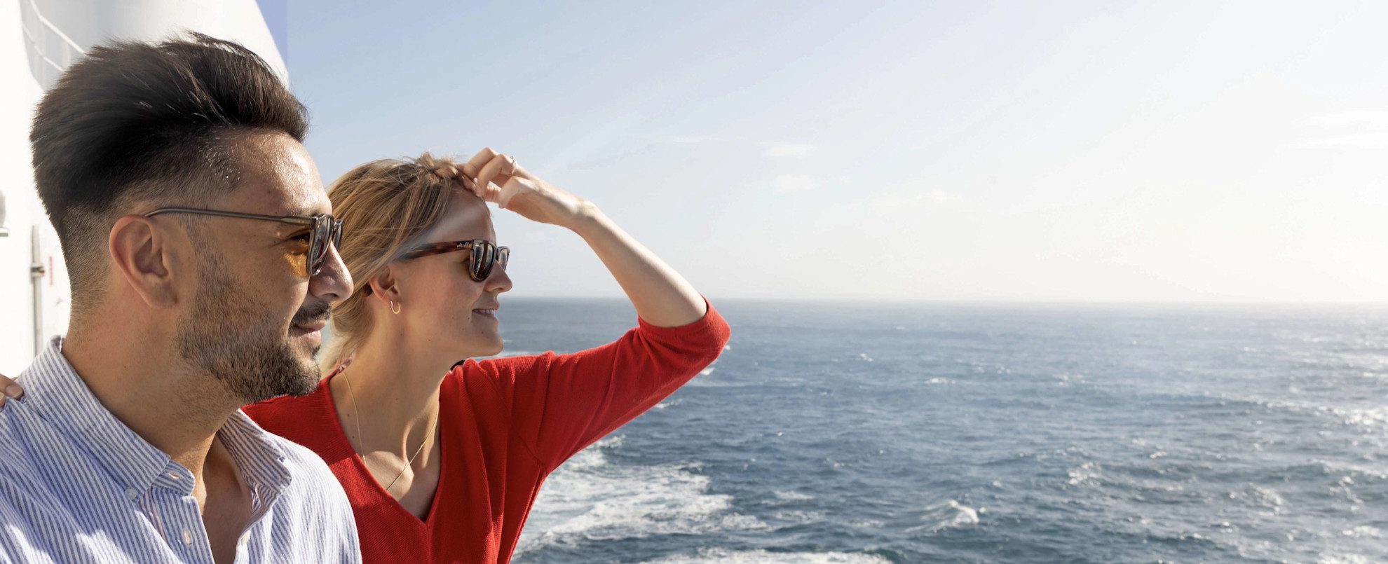 A couple on deck looking out to sea