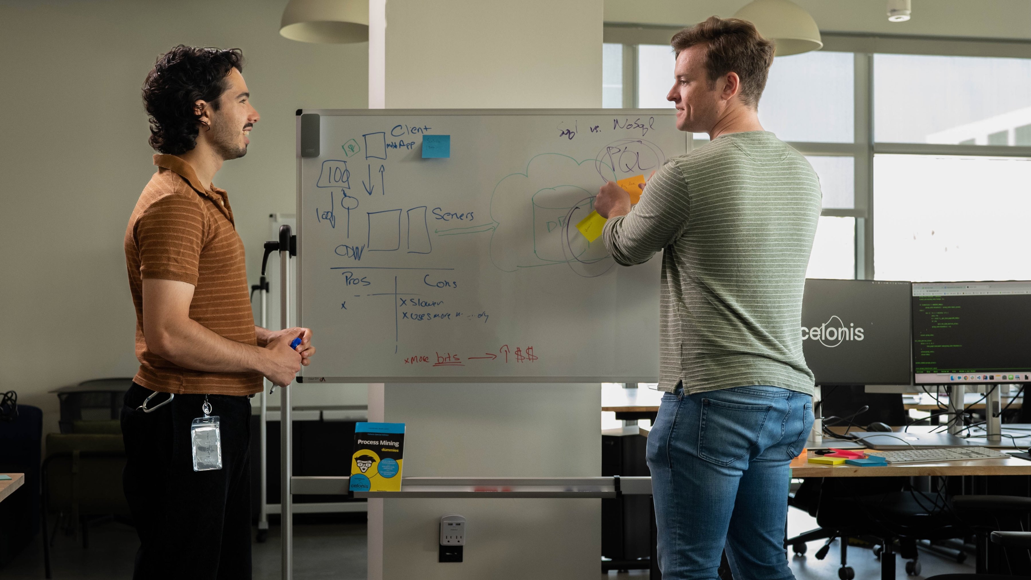 Celonis software engineers Aaron Girard (left) and Alex Monroe (right) work at a whiteboard in the LA office