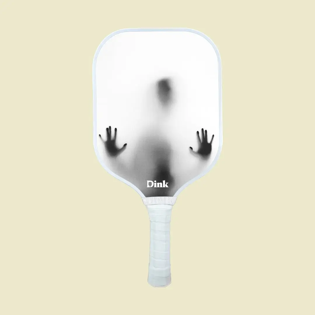 a white pickleball paddle with a scary black ghostly figure