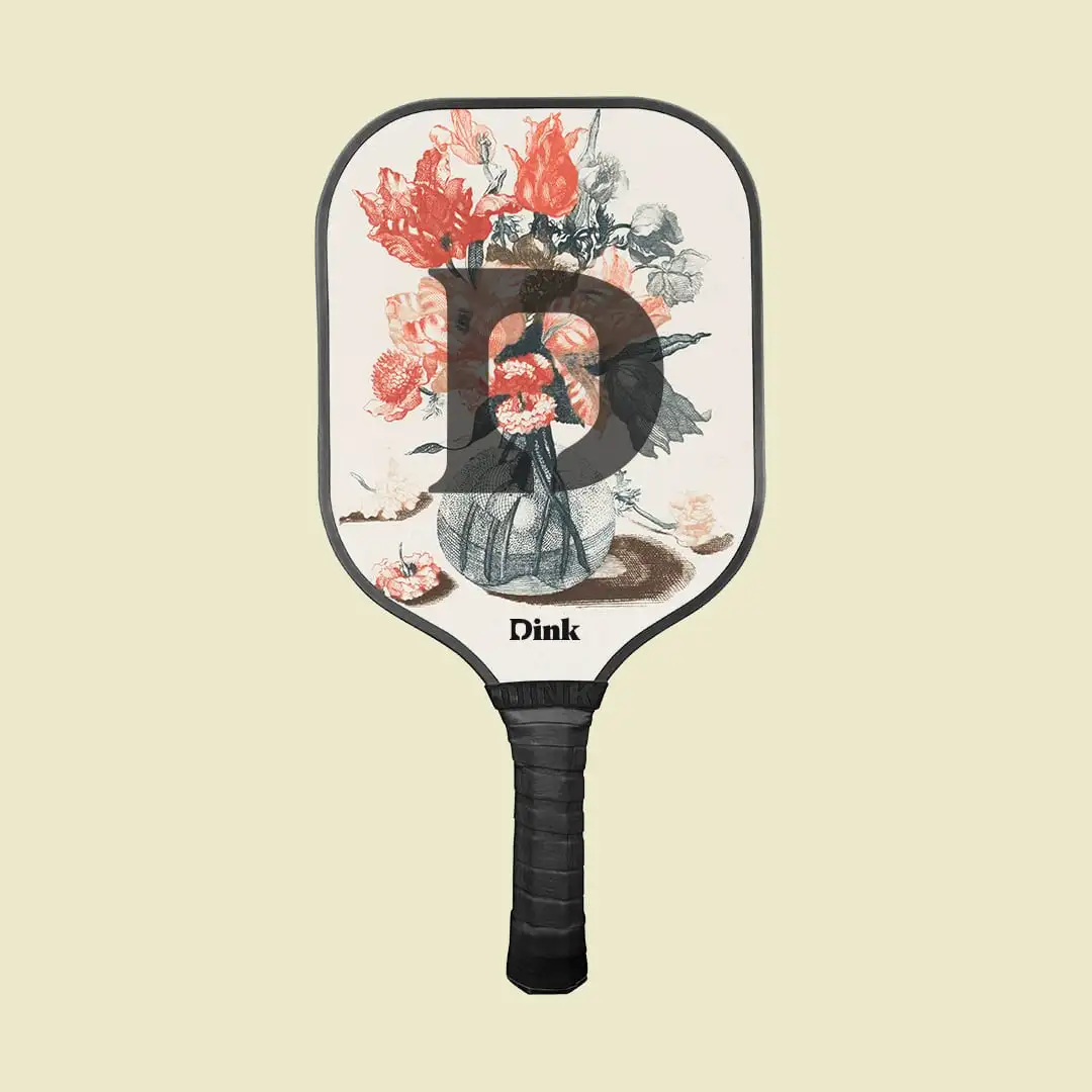 Red flowers on the white pickleball paddle with black edges