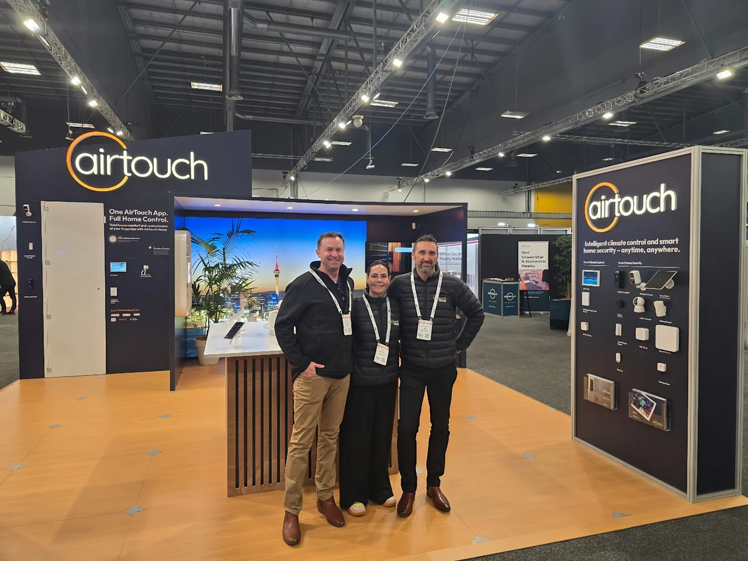Three members of the AirTouch team on the stand at BuildNZ 2026.