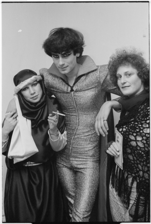 Three people wearing avant garde clothing.