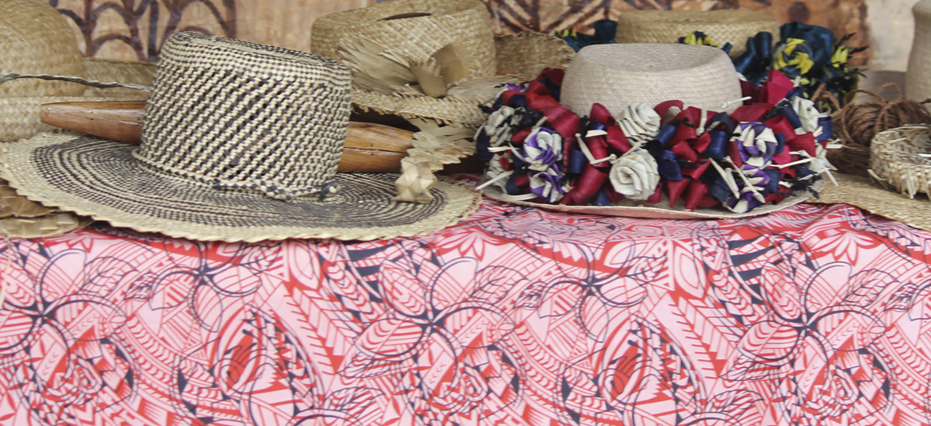 Handwoven hats on display on a table.