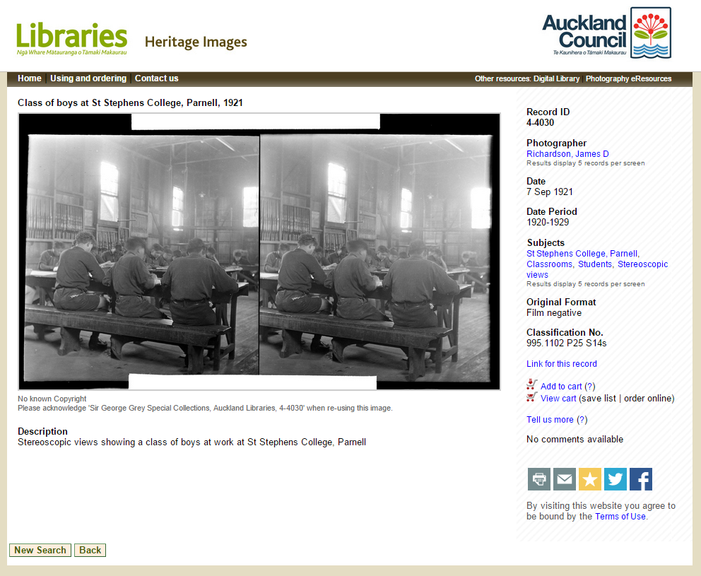 Screenshot of two steroscopic views of three boys sitting on a bench at a table in a large classroom, and the metadata description for the photos