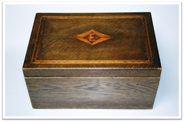 Wooden box with the letter 'E' inlaid in the lid.