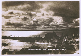 Black and white postcard of the moon reflecting on water with the text 'Moonlight on Rotorua Lake'.