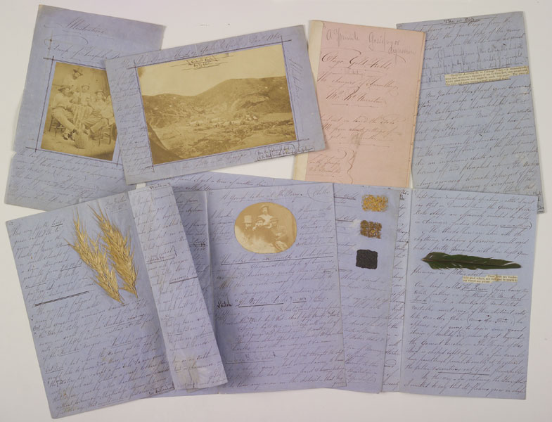 Handwritten letters with photos and pressed leaves.