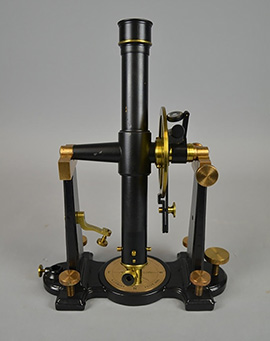 A brass and black transit telescope.