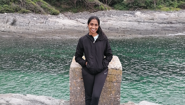 Desree standing in front of water